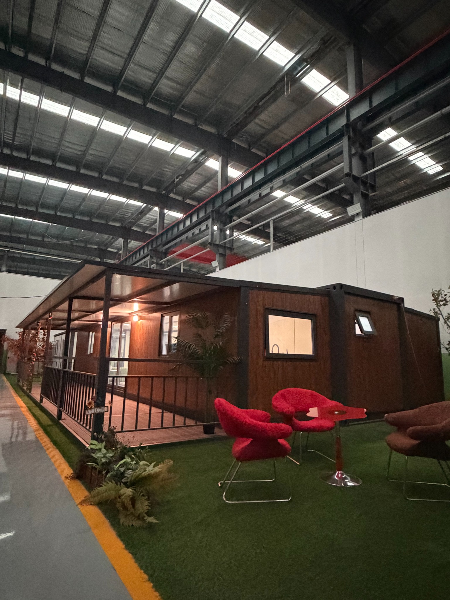 Expandable container house with wood-look exterior and covered porch