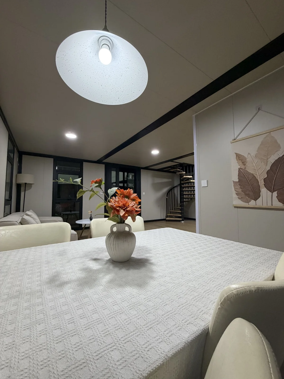 Dining area with internal staircase in double-storey expandable house