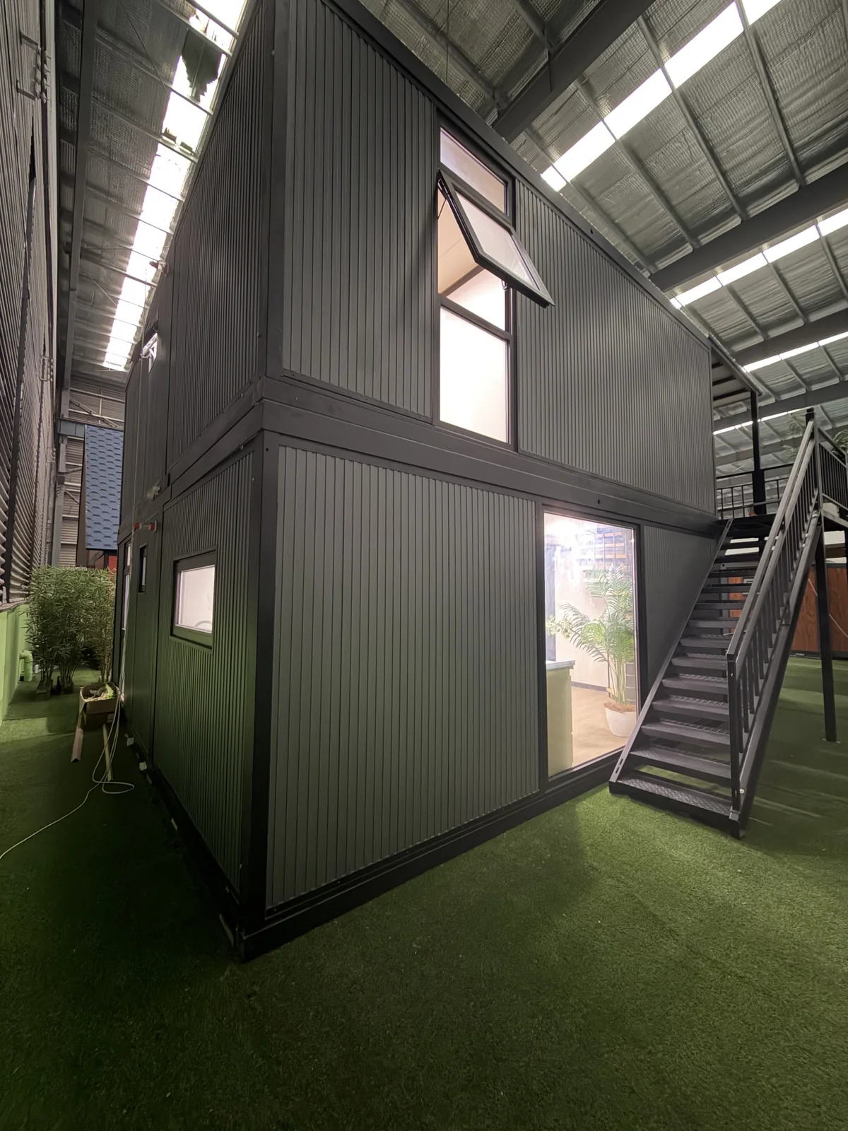 Side view of double-storey expandable house with exterior staircase