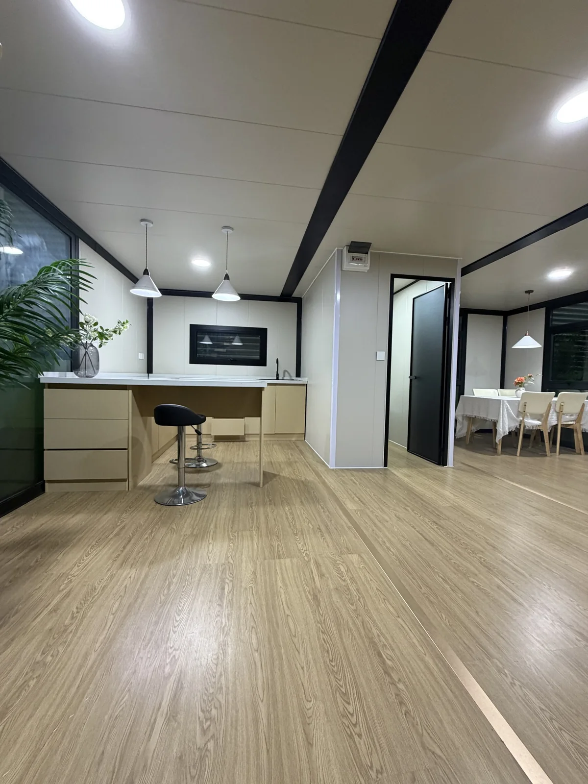Wide kitchen and dining interior in double-storey expandable house